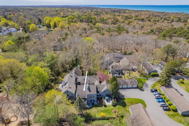 birds eye view of property with a forest view and a water view