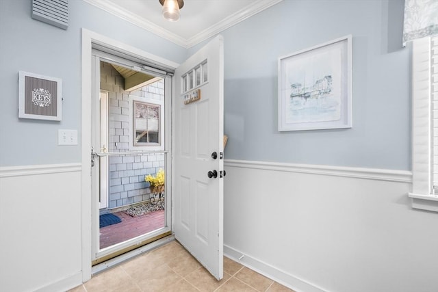 doorway featuring crown molding, baseboards, and tile patterned floors