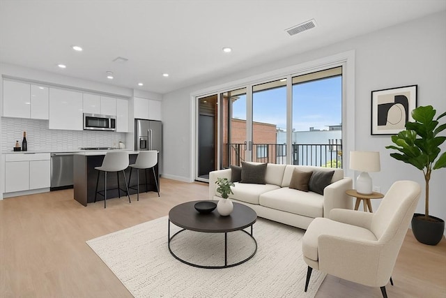 277 Border St Unit 502, Boston, MA 02128 - living area with light wood-style flooring and recessed lighting