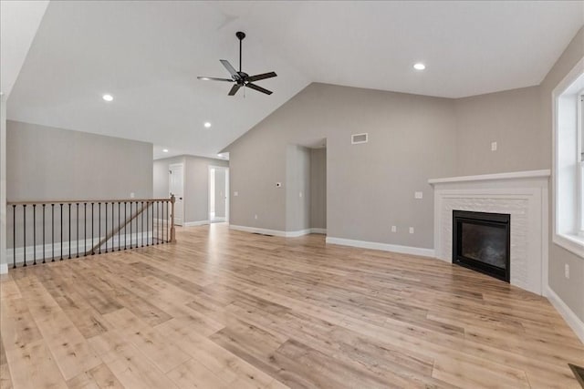 6 Nicols Way Unit 6, Easthampton, MA 01027 - unfurnished living room featuring ceiling fan, light wood-style flooring, vaulted ceiling, a glass covered fireplace, and recessed lighting