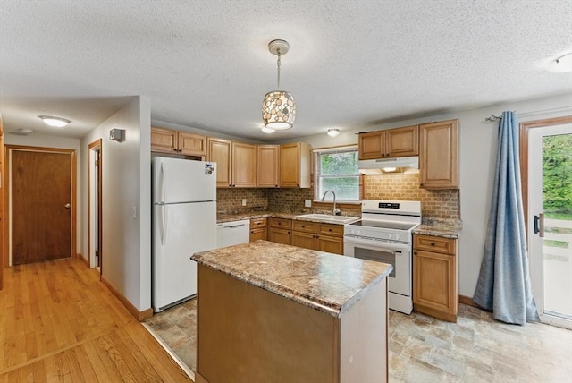 215 Pine Acre Rd, Springfield, MA 01129 - kitchen featuring white appliances, under cabinet range hood, a sink, a textured ceiling, and backsplash