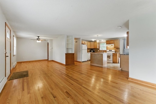 215 Pine Acre Rd, Springfield, MA 01129 - unfurnished living room with light wood-type flooring, a sink, baseboards, and ceiling fan
