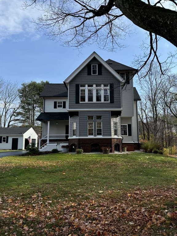 view of front of house with a front yard and covered porch