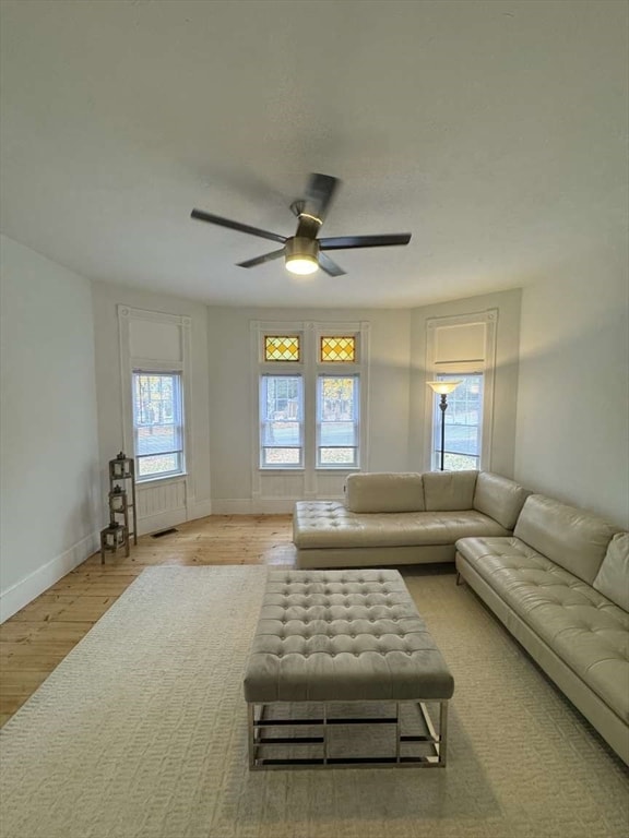 living room featuring light wood-type flooring and ceiling fan