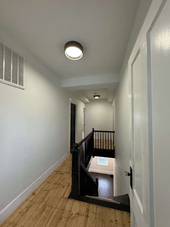 staircase with hardwood / wood-style flooring