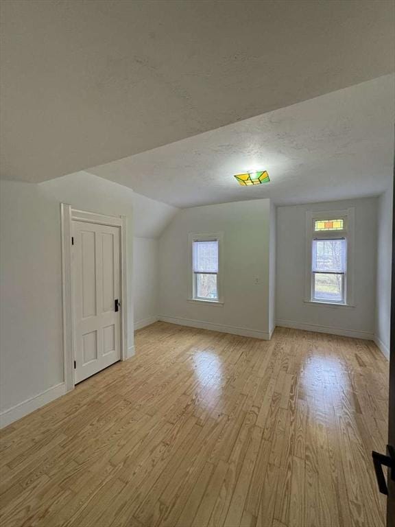473 Massasoit Rd, Worcester, MA 01604 - additional living space featuring lofted ceiling, light wood-style floors, and baseboards