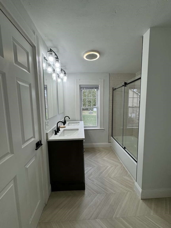 bathroom featuring vanity and bath / shower combo with glass door