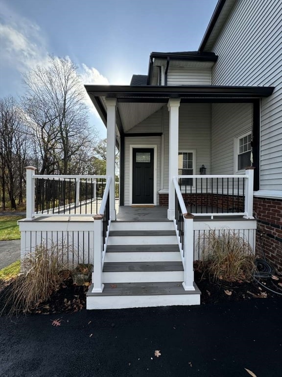 view of exterior entry with covered porch