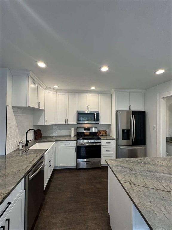 kitchen featuring white cabinetry, stainless steel appliances, sink, and dark hardwood / wood-style flooring