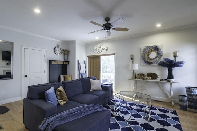 living area with ceiling fan, ornamental molding, recessed lighting, wood finished floors, and baseboards