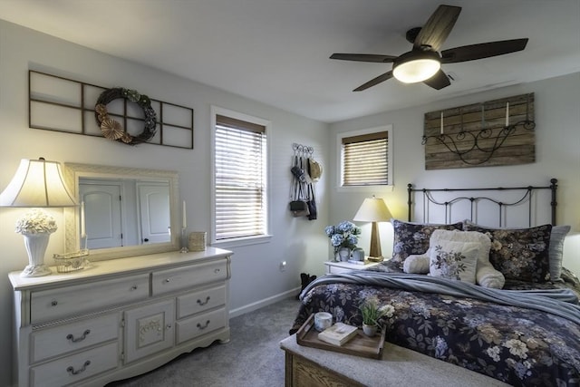 carpeted bedroom featuring baseboards and ceiling fan