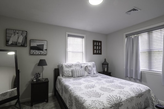 bedroom featuring baseboards, carpet, and visible vents