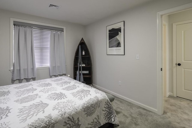 bedroom with light carpet, visible vents, and baseboards