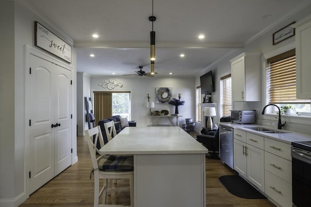 kitchen with dark wood-style floors, a center island, white cabinets, stainless steel dishwasher, and a sink