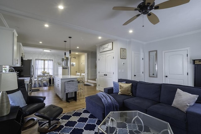 living area with recessed lighting, light wood finished floors, a ceiling fan, and ornamental molding