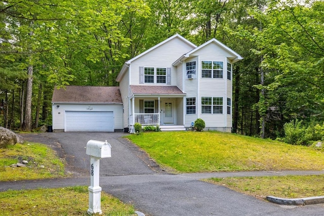 68 Ice Pond Dr, Northampton, MA 01062 - traditional home with covered porch, a garage, asphalt driveway, and a front yard