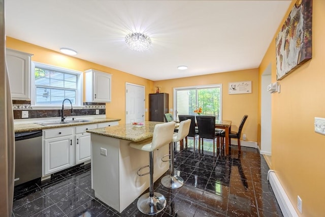 68 Ice Pond Dr, Northampton, MA 01062 - kitchen with a sink, stainless steel dishwasher, a baseboard radiator, a kitchen island, and white cabinets