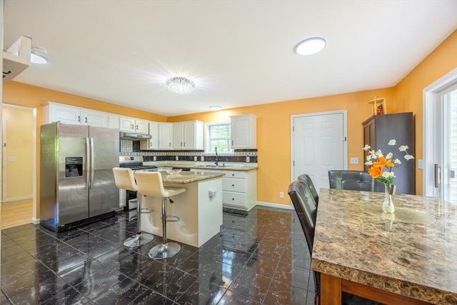 68 Ice Pond Dr, Northampton, MA 01062 - kitchen with stainless steel appliances, a sink, white cabinets, under cabinet range hood, and a kitchen island