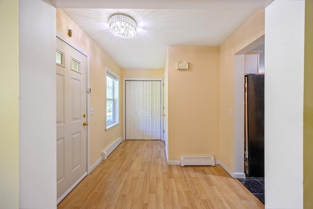 68 Ice Pond Dr, Northampton, MA 01062 - entrance foyer featuring a baseboard radiator, a chandelier, light wood finished floors, and baseboards