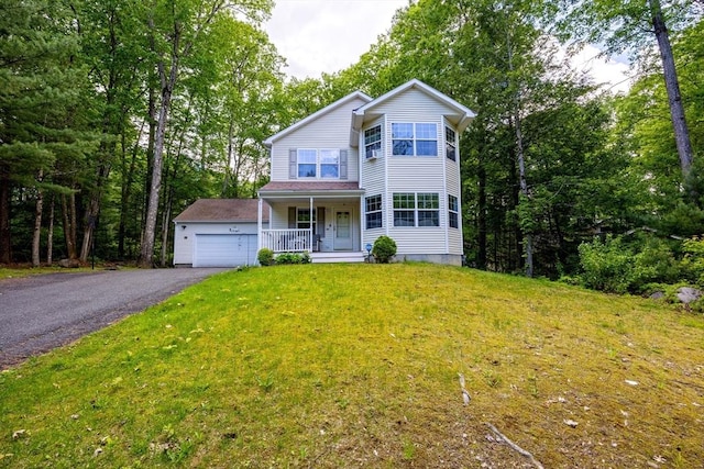 68 Ice Pond Dr, Northampton, MA 01062 - traditional-style home with covered porch, a front yard, asphalt driveway, and a garage
