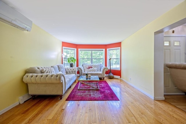 68 Ice Pond Dr, Northampton, MA 01062 - living room with a wall mounted air conditioner, light wood finished floors, and baseboards