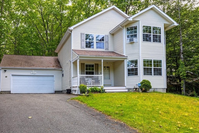 68 Ice Pond Dr, Northampton, MA 01062 - traditional-style home with a porch, asphalt driveway, a front yard, and an attached garage