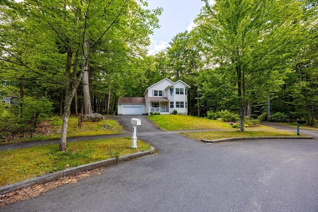 68 Ice Pond Dr, Northampton, MA 01062 - view of front facade featuring asphalt driveway, a front lawn, and a wooded view