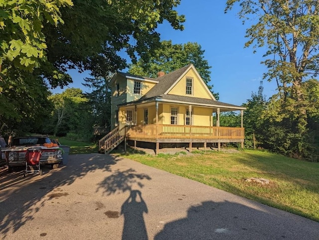 farmhouse with a chimney and a front yard
