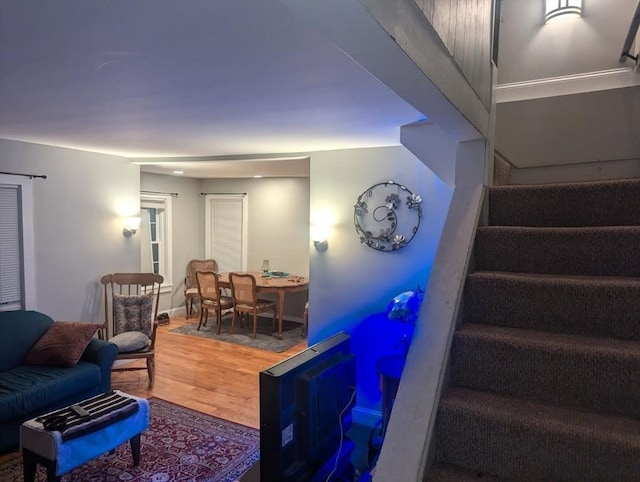 living room with stairway and wood finished floors