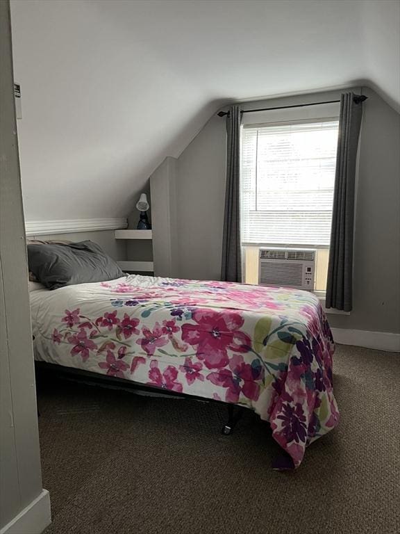 bedroom with vaulted ceiling, cooling unit, carpet floors, and baseboards