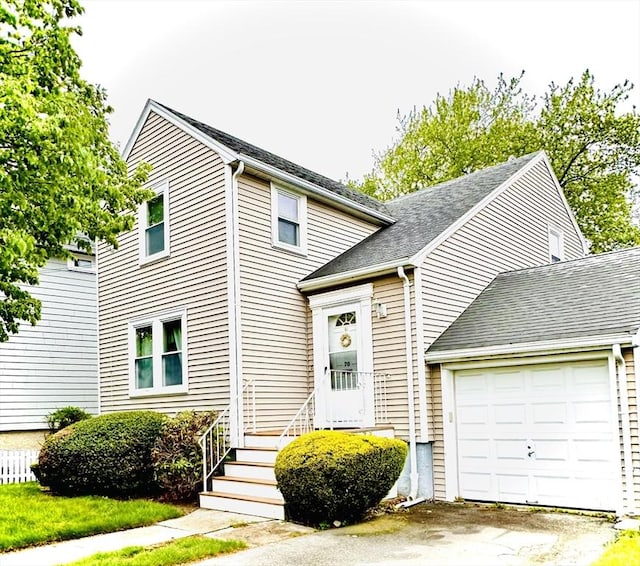 70 Sherman St, Quincy, MA 02170 - traditional-style home with an attached garage, driveway, and a shingled roof