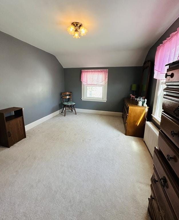 70 Sherman St, Quincy, MA 02170 - living area featuring vaulted ceiling, light colored carpet, radiator, and baseboards