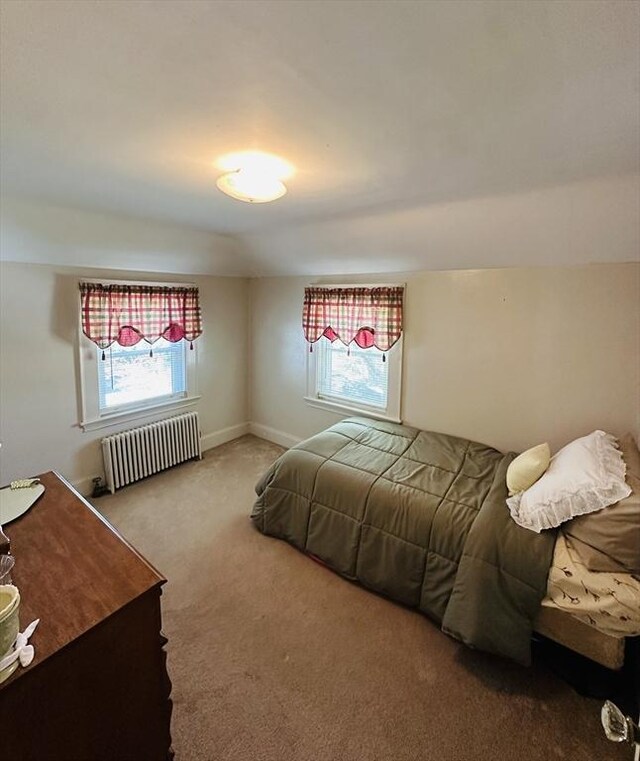 70 Sherman St, Quincy, MA 02170 - carpeted bedroom featuring radiator heating unit, multiple windows, and baseboards