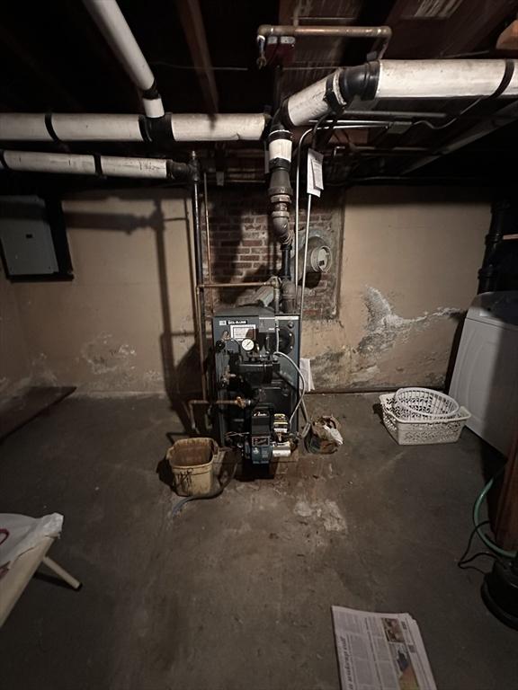 70 Sherman St, Quincy, MA 02170 - unfinished below grade area with washer / clothes dryer, electric panel, and a heating unit