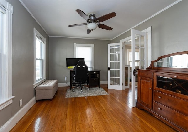 office area with french doors, baseboards, crown molding, and light wood-style floors