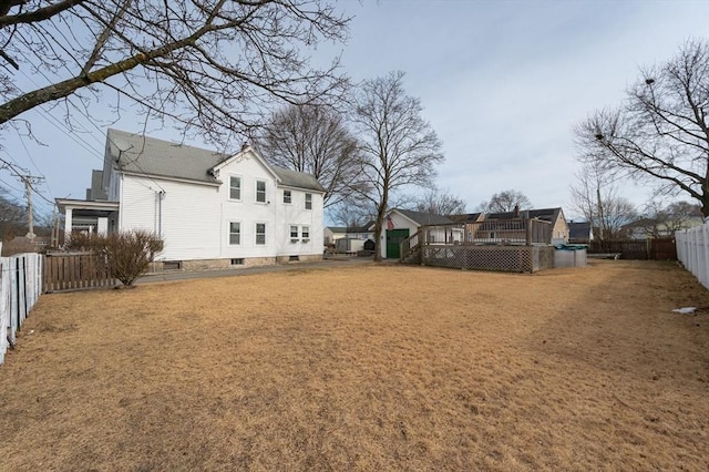 view of yard featuring a wooden deck and a fenced backyard