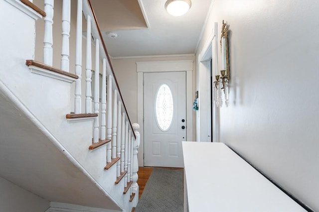 entrance foyer featuring wood finished floors and ornamental molding