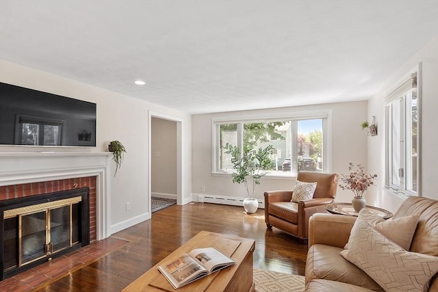 286 Laurel St, Melrose, MA 02176 - living room with a baseboard heating unit, wood finished floors, baseboards, a brick fireplace, and recessed lighting