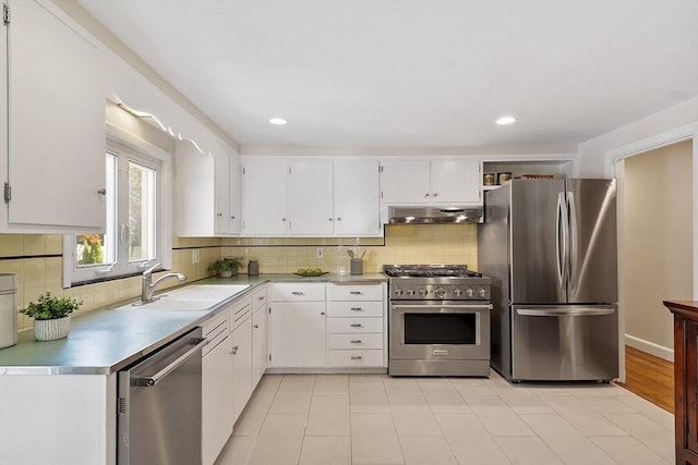 286 Laurel St, Melrose, MA 02176 - kitchen featuring stainless steel appliances, under cabinet range hood, a sink, white cabinetry, and recessed lighting