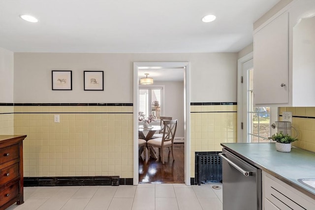 286 Laurel St, Melrose, MA 02176 - kitchen featuring tile walls, stainless steel dishwasher, white cabinets, a wainscoted wall, and a baseboard heating unit