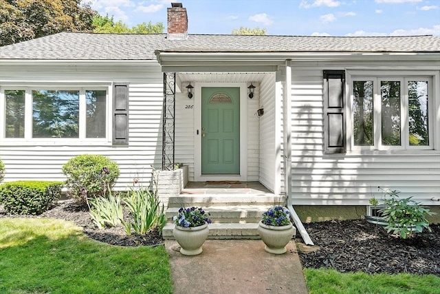 286 Laurel St, Melrose, MA 02176 - doorway to property with a chimney and a shingled roof