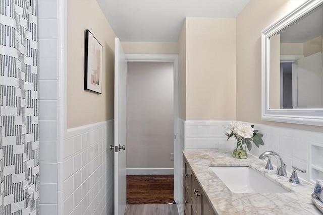 286 Laurel St, Melrose, MA 02176 - full bath featuring tile walls, vanity, wood finished floors, wainscoting, and a shower with curtain