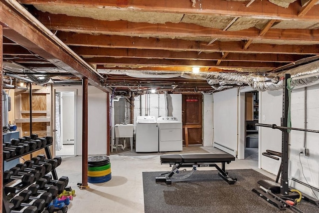 286 Laurel St, Melrose, MA 02176 - exercise room with washing machine and clothes dryer, a baseboard heating unit, a sink, and baseboard heating