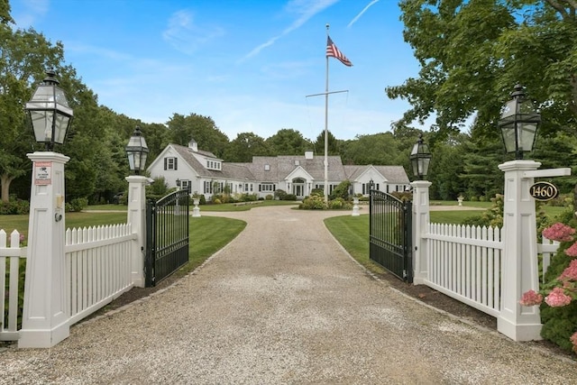 view of gate featuring a fenced front yard and a yard