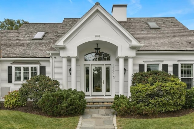 property entrance featuring a chimney