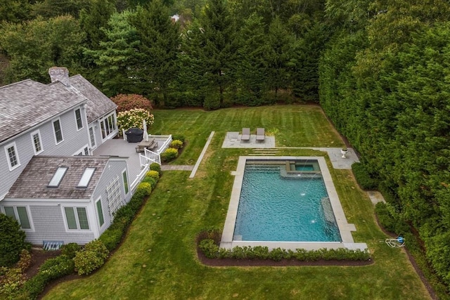 pool with a yard and a patio