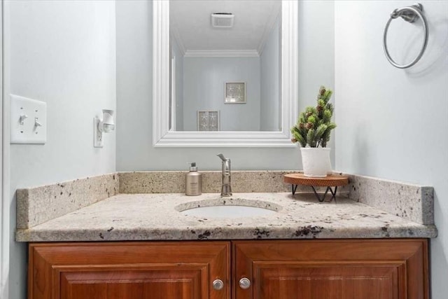 bathroom with visible vents, vanity, and crown molding