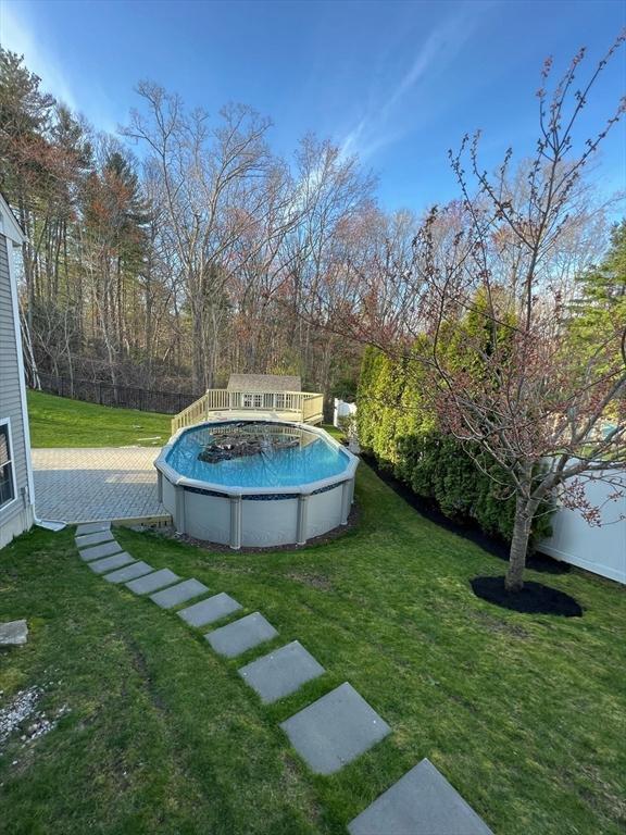 outdoor pool with a yard