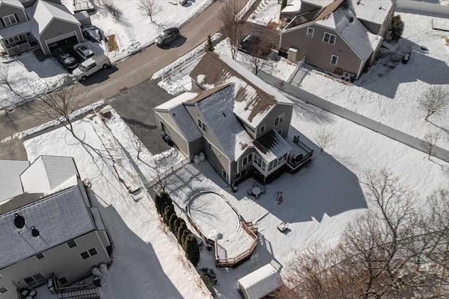 snowy aerial view with a residential view