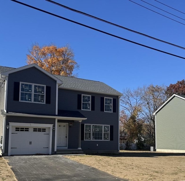 view of front facade with driveway and an attached garage